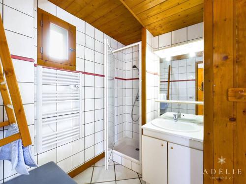 a bathroom with a sink and a shower and a mirror at Appartement Montvalezan-La Rosière, 5 pièces, 8 personnes - FR-1-398-644 in Montvalezan