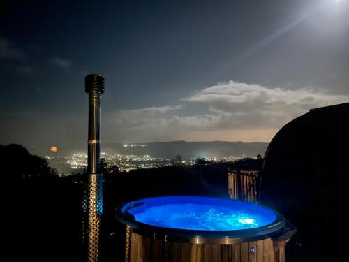 a blue tub with a city in the background at Stoneymollan over Loch Lomond in Balloch