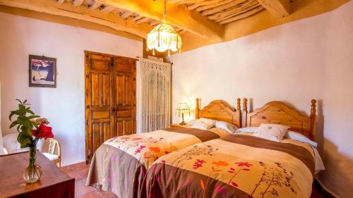 a bedroom with a large bed in a room at Casa Africa La Taha - Mecina Fondales by Ruralidays in Granada