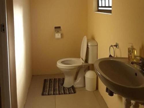 a bathroom with a toilet and a sink at Claytons accommodation in Bedford