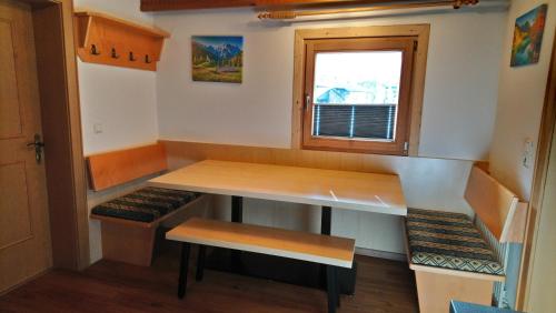a tiny house with a table and benches at Landhaus Eberler in Mayrhofen