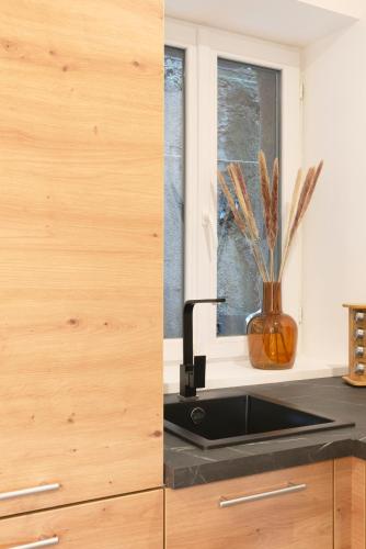 a kitchen with a sink and a window at LE 23 in Jarny