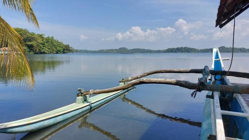 a boat is docked on a body of water at Bandulas Beach House in Hikkaduwa