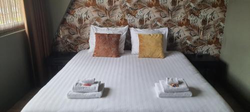 a bed with towels and pillows on it at Sientjes Boetiekhotel in Kerkdriel