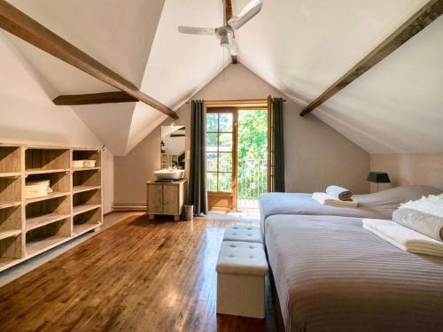 a attic bedroom with two beds and a window at Domaine des Grands Bois Privatisé in Sergeac