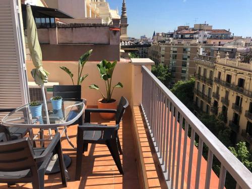 a balcony with a table and chairs and a view of a city at Top Barcelona Apartments in Barcelona