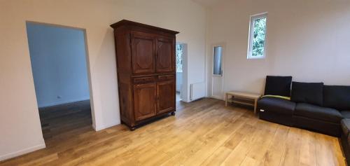 a living room with a couch and a dresser at Domaine de Coulonge 