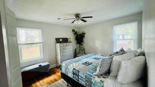 um quarto com uma cama e uma ventoinha de tecto em Newly Renovated Historic Home Near Park Circle em Charleston