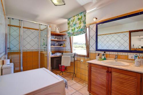 a bathroom with a sink and a shower at Finca Marina BuenVivir in Tazacorte