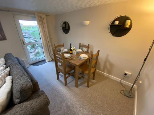 a living room with a table and a couch at Stunning Cottage in Holyhead in Holyhead
