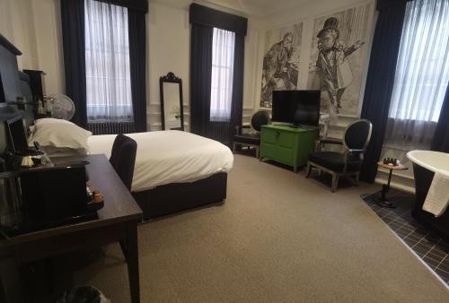 a hotel room with a bed and a desk and a television at Judges Court in York