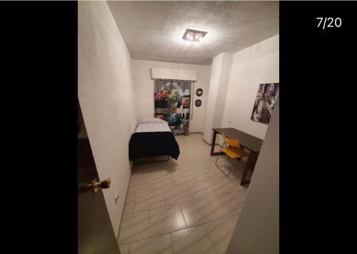 a room with a bed and a table in a room at BE LIKE AT HOME PARIS in Alcalá de Henares