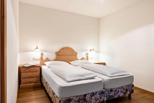 Cesa Valeria App Sonia في أورتيساي: غرفة نوم بسرير من اللوح الخشبي ومصباحين