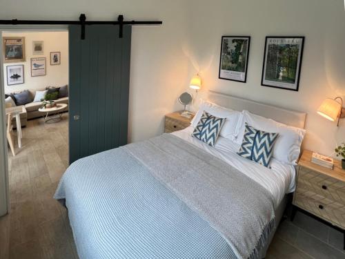 a bedroom with a large bed and a living room at Forge Cottage - Pretty 1 Bedroom Cottage with Free Off Street Parking in London