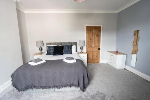 a bedroom with a bed with two towels on it at Seascape Cottage in Haverigg