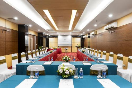 a large conference room with blue tables and chairs at Bao Son International Hotel in Hanoi