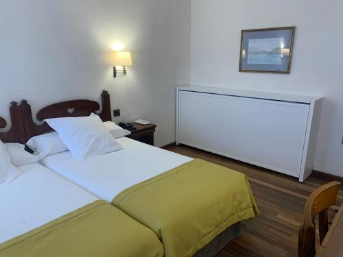 a bedroom with a bed and a desk at Parador de Las Cañadas del Teide in La Orotava