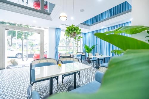 a room with tables and chairs and a window at Bao Son International Hotel in Hanoi