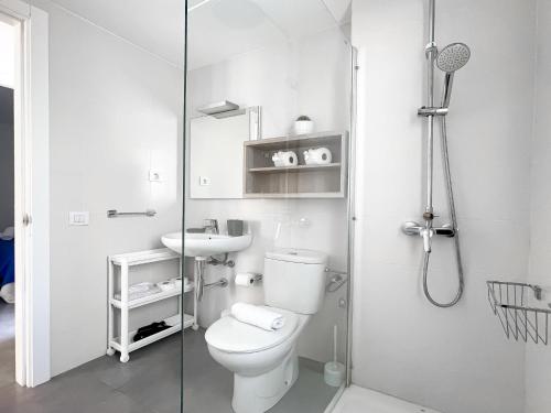 a bathroom with a toilet and a sink and a shower at Los Barqueros 16 by Best Holidays Fuerteventura in Corralejo