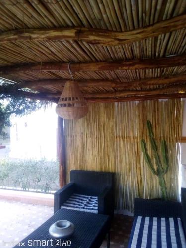 a room with a couch and a table and a ceiling at Villa Al Kharoube in Essaouira