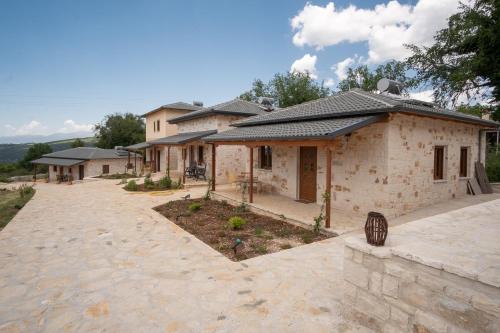 a house with a stone driveway in front of it at okakosolykos in Kostitsi