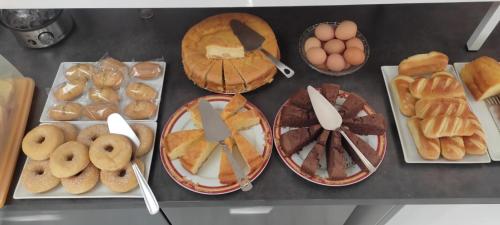 a bunch of different types of bread and pastries on a counter at Contact Hôtel Arc-En-Ciel - Réouverture - Rénové in Mulhouse
