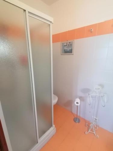 a glass shower in a bathroom with a toilet at SelfMatic in Orio al Serio