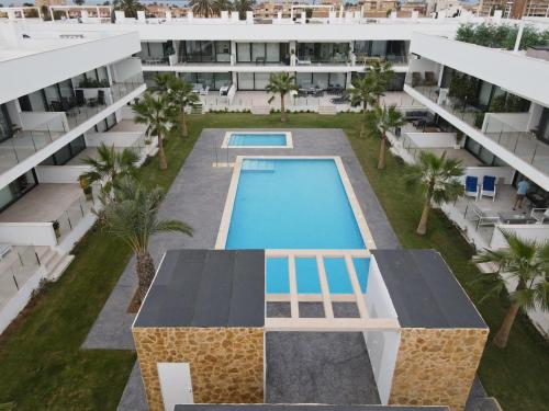 an aerial view of an apartment building with a swimming pool at Outstanding 2 bed apartment with rooftop sea views in Mar de Cristal