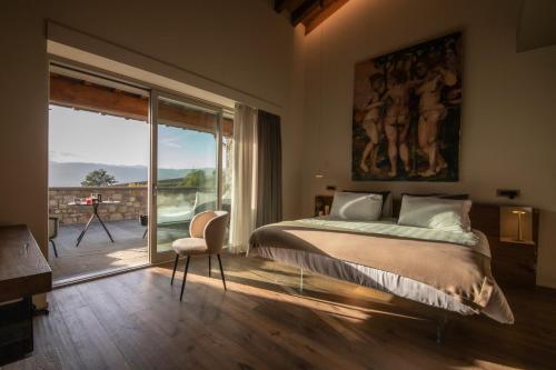 a bedroom with a large bed and a large window at Borgo Corsignano in Poppi