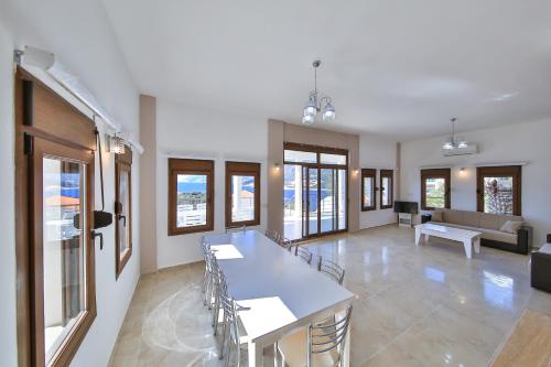 a living room with a table and chairs and a couch at James Pansiyon Blue sea view villas Kaş Peninsula in Kas