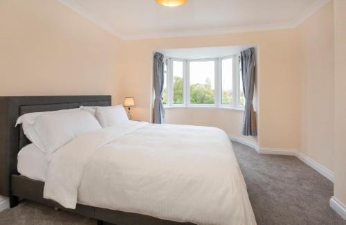 a bedroom with a large white bed and a window at Peace house - 56 Sycamore Terrace in York