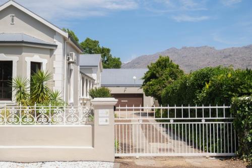a white fence in front of a house at The Lemon Tree in Ceres