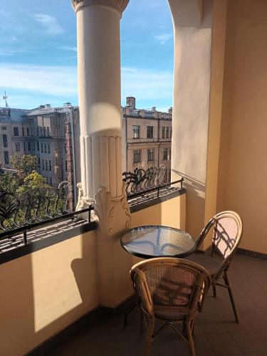 a balcony with a table and a chair and a window at TRIBE Riga City Centre in Rīga