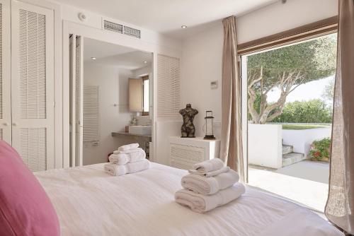 a bedroom with a white bed with towels on it at Deluxe Ibizan Retreat Stunning Sea Views Can Juana 6 Bedroom A short Drive to The Beach San Jose in Sant Josep de sa Talaia