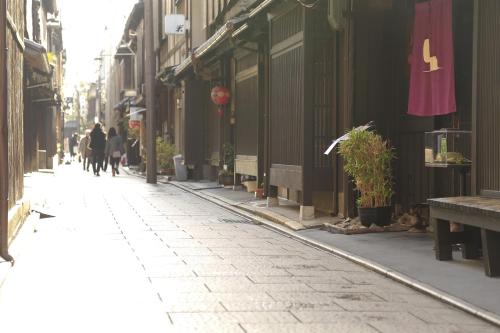 a city street with people walking down the street at Sauna & Capsule Hotel Rumor Plaza in Kyoto