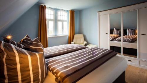 Ένα ή περισσότερα κρεβάτια σε δωμάτιο στο Parkresidenz Lychen, Ferienwohnung 6