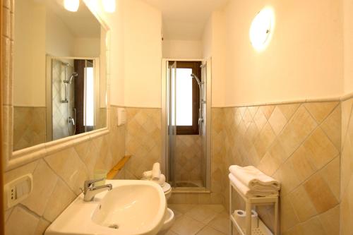 a bathroom with a sink and a shower and a toilet at CHIA HOMES in Chia