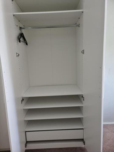 a closet with white walls and white shelves at Alte Bibliothek in Kottmar