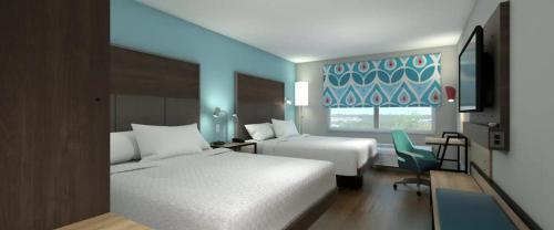 Tru By Hilton Wilmington في ويلمنجتون: غرفة فندقية بسريرين ونافذة