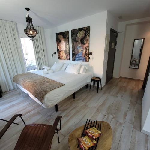 a bedroom with a large bed and a wooden floor at Terrace Costa Hotel in Fuengirola