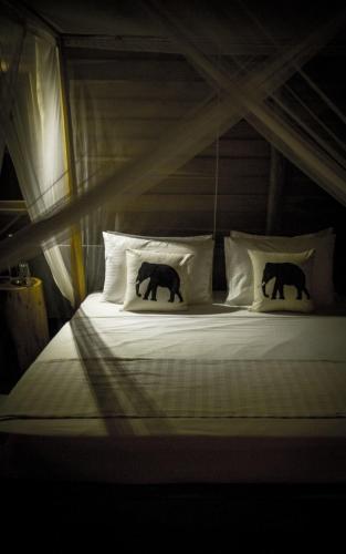 two elephants on a bed in a room at Gal Oya Lodge in Galgamuwa