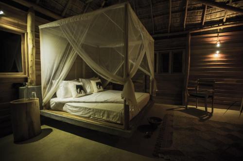a bedroom with a bed with a canopy at Gal Oya Lodge in Galgamuwa