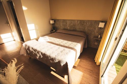 a hotel room with a bed and a window at Hôtel le Panoramic - Votre Hôtel au cœur des Gorges du Verdon in La Palud sur Verdon
