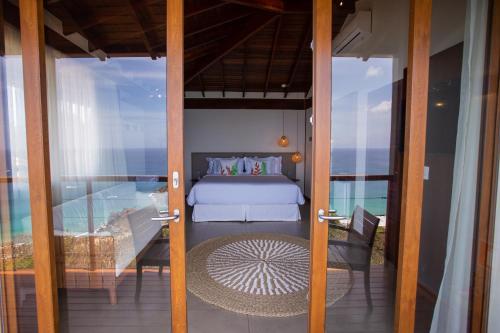 a bedroom with a bed on a balcony at Pousada Ecológica Akanã in Fernando de Noronha