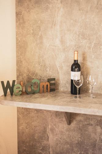 a bottle of wine and a glass on a shelf at Hôtel le Panoramic - Votre Hôtel au cœur des Gorges du Verdon in La Palud sur Verdon