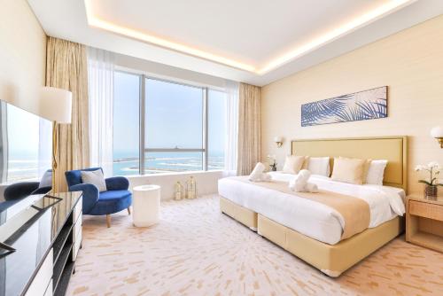 a bedroom with a large bed and a large window at Ultra Luxury Palm Tower with Shared Hotel Facilities in Dubai