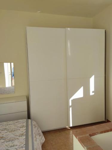 a bedroom with a white closet and a bed at Da Piero & Lilia in Centola