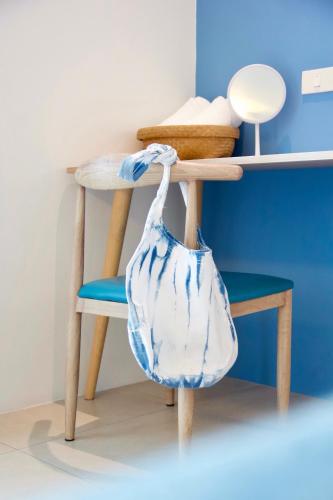a blue and white bag sitting on a chair at DeeProm Pattaya Hotel in Pattaya Central