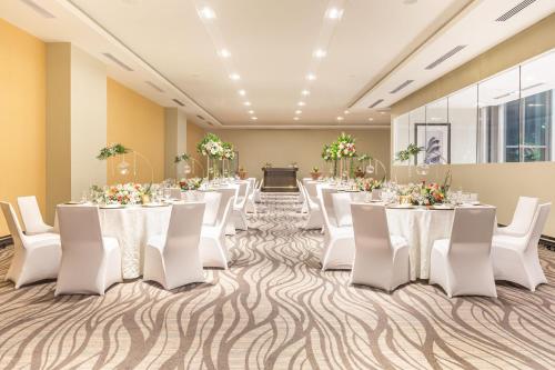a banquet hall with white tables and white chairs at Marriott Panama Hotel - Albrook in Panama City