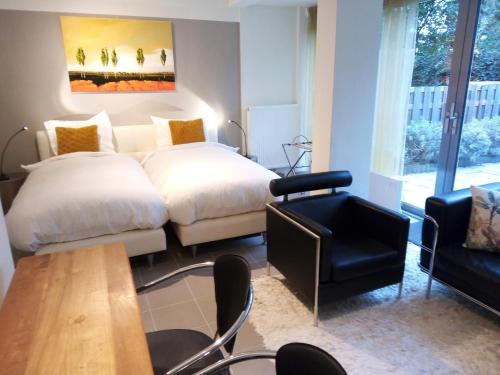 a bedroom with a bed and a chair and a table at At number 6 in Amsterdam